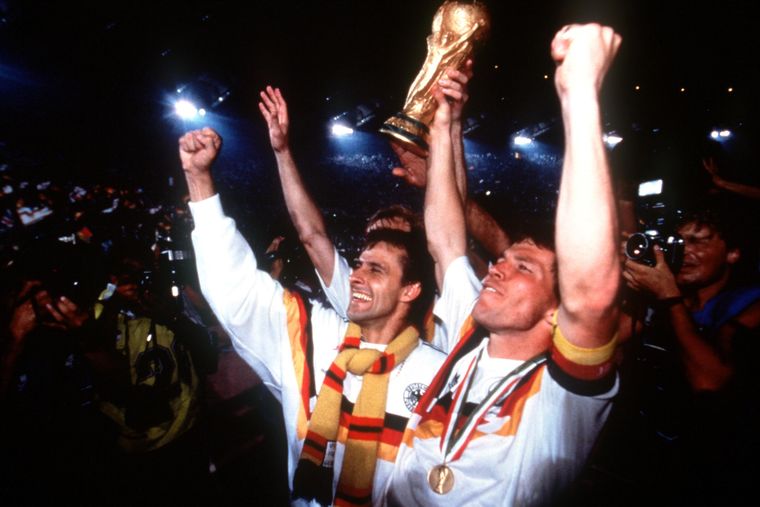 Era of dominance: Germany’s Pierre Littbarski (left) and Lothar Mätthaus celebrate the 1990 World Cup triumph | Getty Images