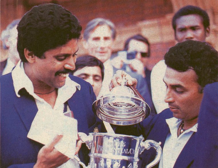 Indian captain Kapil Dev and Sunil Gavaskar inspect the 1983 trophy.