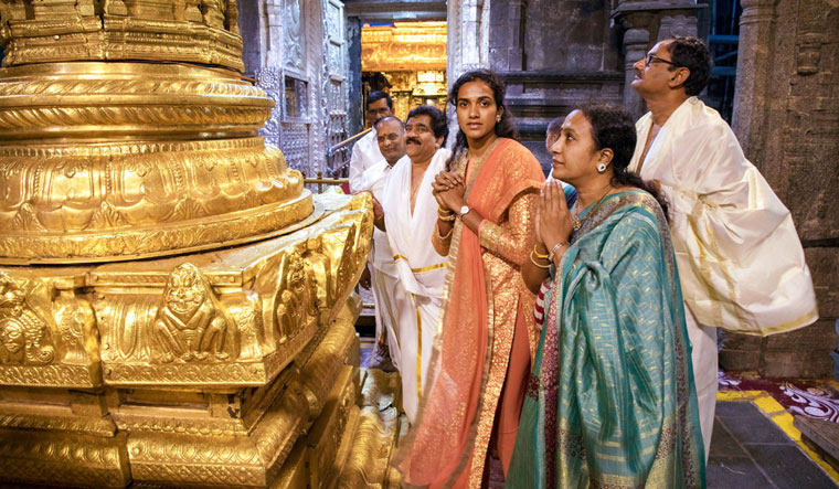 Parents and prayers: Sindhu with mother, Vijaya, and father, P.V. Ramana (right), at the Sri Venkateswara Swamy Temple in Chittoor, Andhra Pradesh | PTI