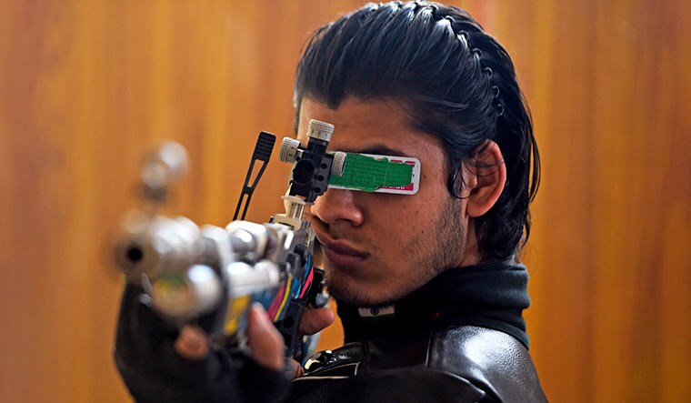 Eyeing glory: Divyansh singh panwar takes aim in an apartment in faridabad that was converted into a practice range | AFP