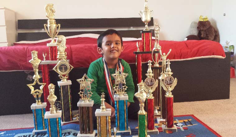Little joys: Abhimanyu, aged five, with his chess trophies at home.