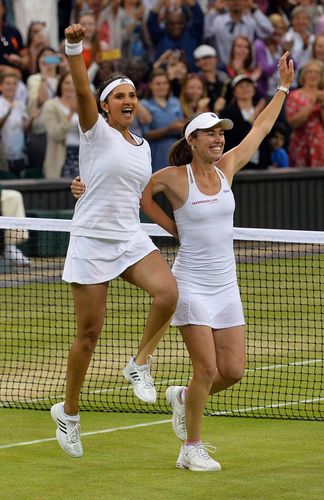 Legendary duo: Mirza with Switzerland’s Martina Hingis after winning Wimbledon; the duo, dubbed SanTina, went on a 41-match winning streak in 2015 and 2016—the third best in women’s doubles | AFP