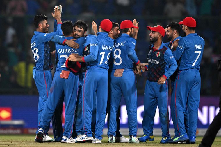 Joyful upset: The Afghanistan team celebrates its win over reigning world champions England on October 15 | AFP