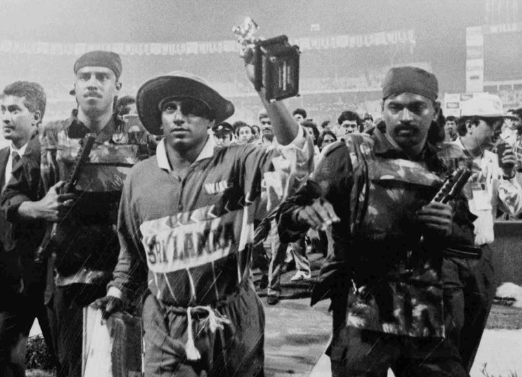 A day to forget: Aravinda De Silva, with his player of the match trophy, escorted from the field by Indian commandos after the 1996 semi-final between India and Sri Lanka was marred by crowd trouble; the match was awarded to Sri Lanka | AP