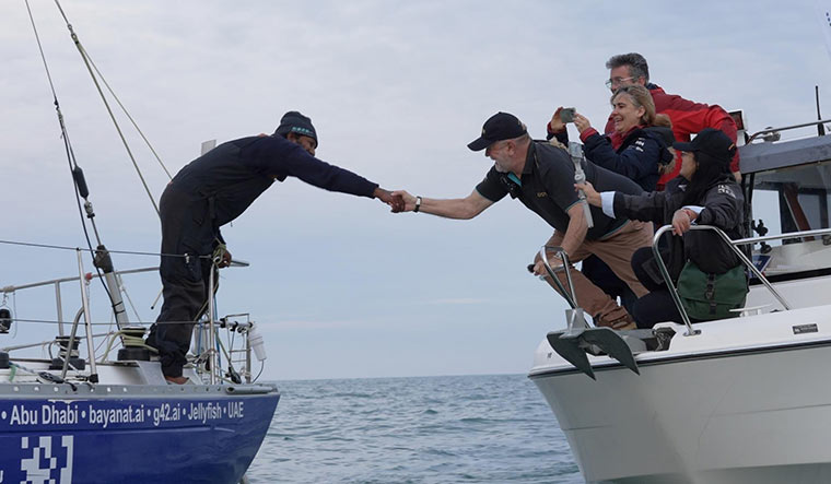 Welcome back: Tomy greeted by Don McIntyre, founder and chairman of the Golden Globe Race.