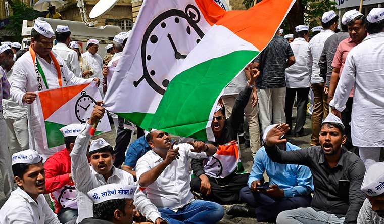Bad news: NCP supporters protesting outside the Enforcement Directorate office in Mumbai, after Sharad Pawar and Ajit Pawar were named in the case | Amey Mansabdar