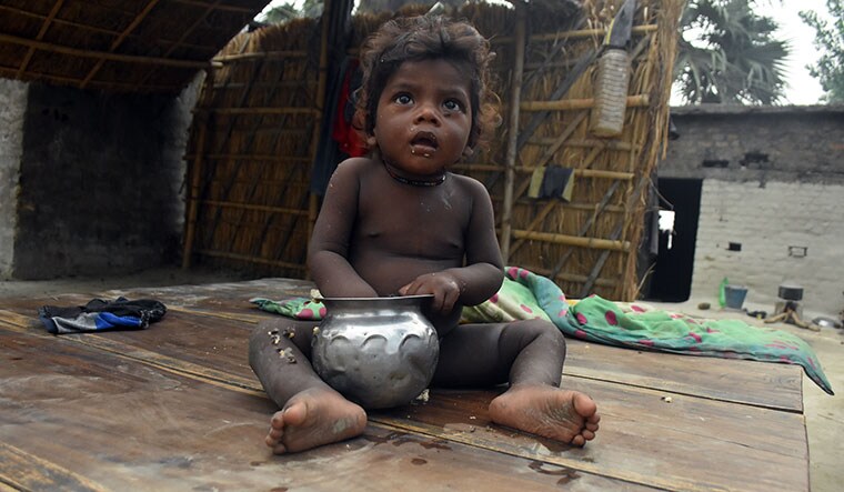 Food for tot: A child eats rice soaked in water at the Musahar community settlement in Manjhi Tola | Deepak Kumar