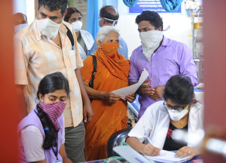 People cover their face at the casualty of the district hospital, after the Coronavirus affected patient was identified in Thrissur | Jeejo John