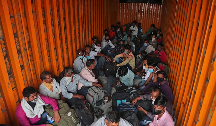 Rough journey: Migrant labourers stuffed inside a goods truck on their way from Hyderabad to their villages in Uttar Pradesh | AP