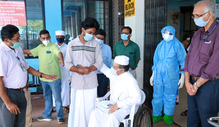 Unique bond: Vineeth Ravi who donated plasma to M.K. Sainuddeen Bhaqavi (in wheelchair) on the day of the latter’s discharge from the Government Medical College in Malappuram: Prasad Manjeri