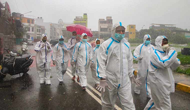 In all weathers: Health workers at a containment zone at Malad in Mumbai | PTI