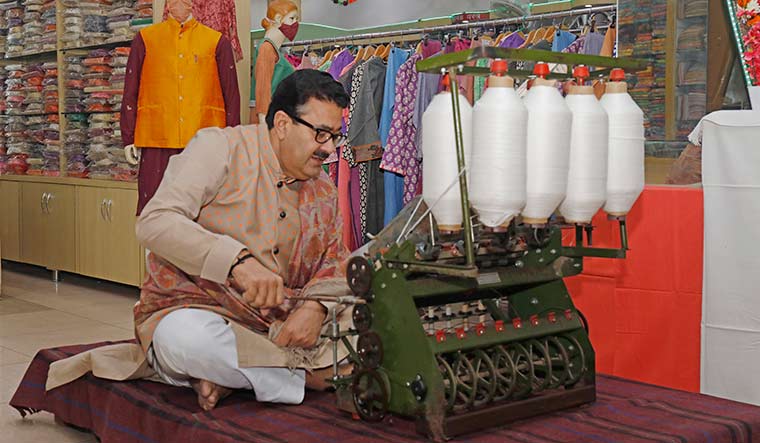Spinning a revival: Navneet Sehgal, additional chief secretary, Uttar Pradesh Khadi and Village Industries Board, works a charkha in Lucknow | Pawan Kumar