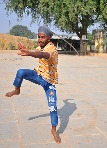 Leap of faith: A youngster in Gachubhai Thanda performing gatka, a Sikh martial art | P. Prasad