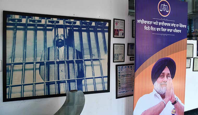 Tough test: An old photo of Parkash Singh Badal and a poster of Sukhbir Badal at the Akali Dal office in Chandigarh | Sanjay Ahlawat