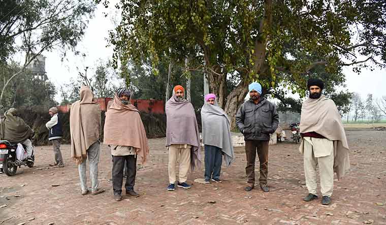 Spirited devotion: People waiting outside Dera Baba Mast Ram premises, hoping to get “liquor prasad” from devotees | Sanjay Ahlawat