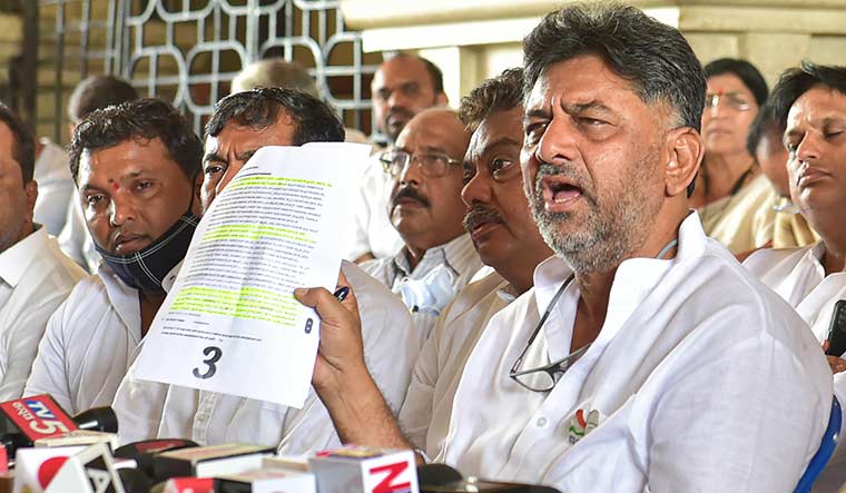 On the front foot: D.K. Shivakumar with his legislators addresses a news conference during a dharna demanding the removal and arrest of Eshwarappa | PTI