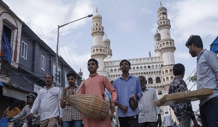 Confluence of cultures: A religious procession under way in the backdrop of the Charminar | Satyanarayana Gola
