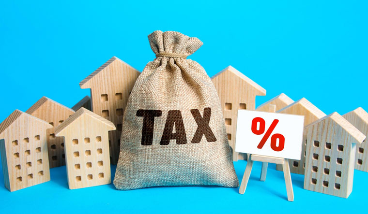 Houses-bag-of-taxes-Real-estate-tax-Taxation-purchase-sale-house-investment-Taxes-relief-shut
