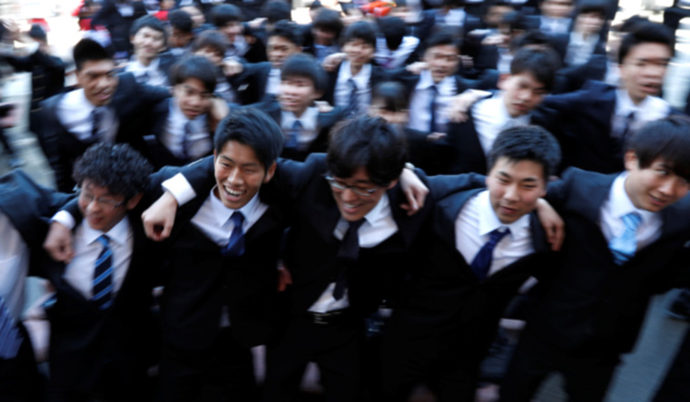 Japanese college students scrum as they shout slogans