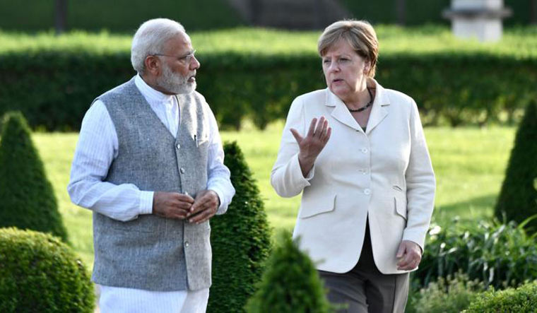 A file photo of Prime Minister Narendra Modi and German Chancellor Angela Merkel | AFP