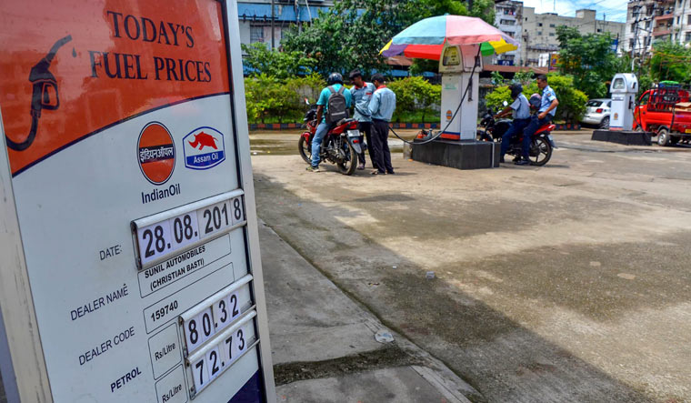 A board displays the petrol and diesel prices at a petrol pump in Guwahati as on August 28 | PTI