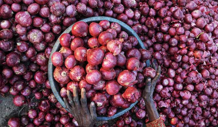 A woman sorts onions at a wholesale vegetable market, in Amritsar on Monday, December 2, 2019 | PTI