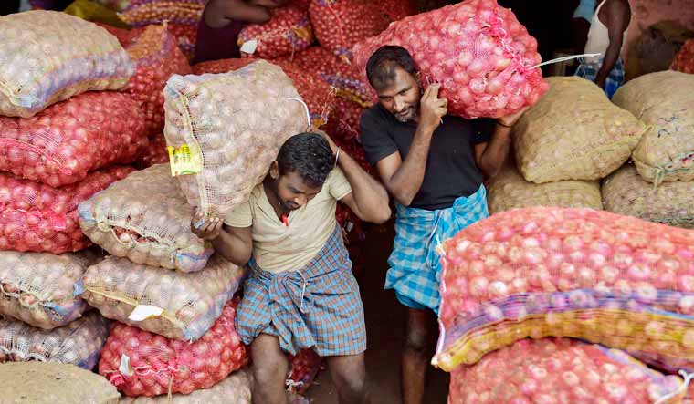 Workers carry onion sacks at Koyambedu wholesale market, in Chennai , Thursday, Dec. 5, 2019 | PTI