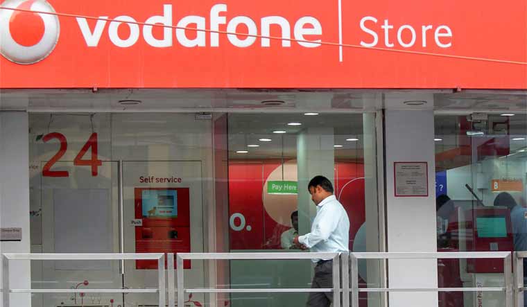 A visitor walks in a Vodafone store in Bangalore | PTI