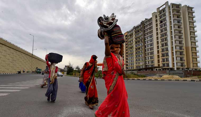 A group of migrant workers walk to their villages amid the nationwide complete lockdown, on the NH24 near Delhi-UP Border in New Delhi | PTI