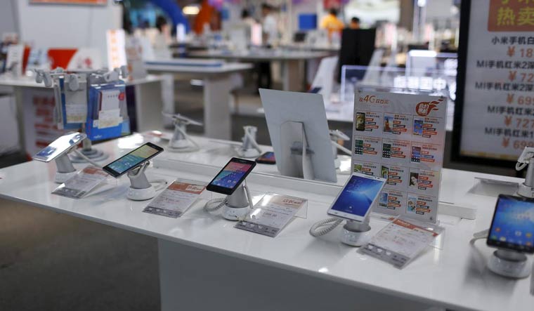 [File] Mobile phones are seen on display at an electronics market in Shanghai | Reuters