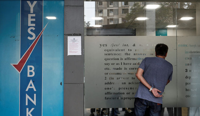 A customer tries to look into a Yes Bank branch in Mumbai | Reuters