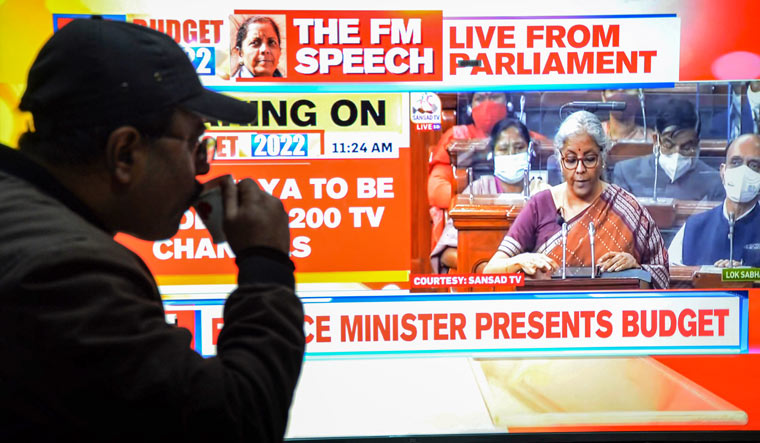 A man watches Finance Minister Nirmala Sitharaman presenting the Union Budget in Parliament, on a television set in Amritsar | PTI