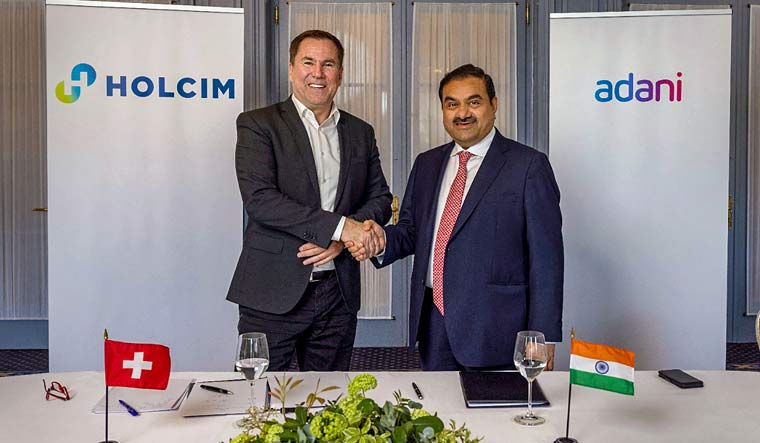 Adani Group Chairman Gautam Adani with Holcim CEO Jan Jenisch. Adani Group has announced deal to acquire Holcim's businesses in India for USD 10.5 bn. | PTI