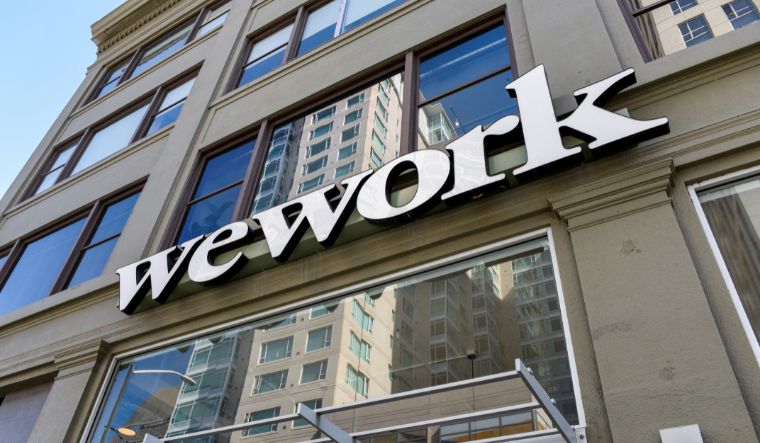 A WeWork logo is seen outside its offices in San Francisco, California | Reuters