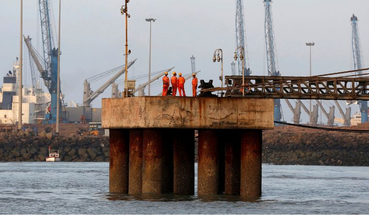 Workers wait for a cargo ship to beach at Mundra Port, operated by Adani Ports and Special Economic Zone Ltd | Reuters