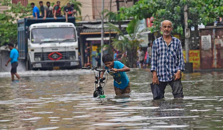 People wade through a water-logged road in Mumbai | Amey S. Mansabdar