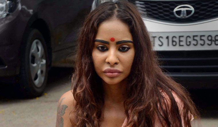 Telugu actor Sri Reddy sits during a 'strip protest' outside the Telugu Film Chamber of Commerce in Hyderabad on Saturday | PTI