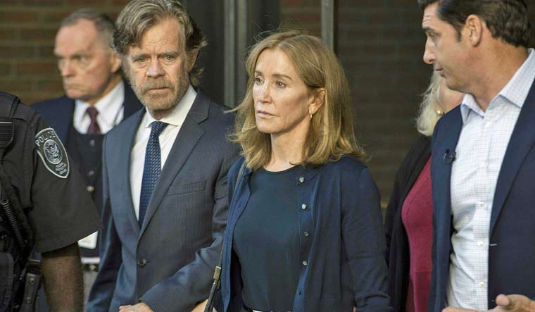 Actor Felicity Huffman and husband William H Macy | AFP