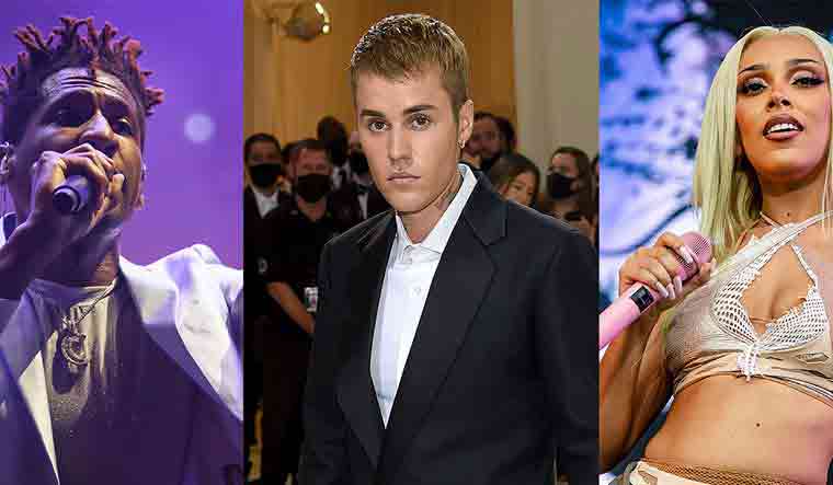 This combination of photos shows Jon Baptiste, Justin Bieber, Doja Cat | AP