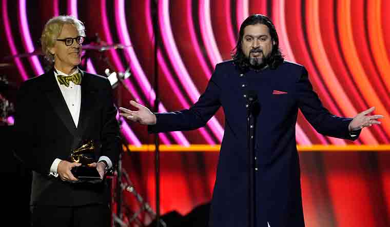 Stewart Copeland, left, and Ricky Kej accept the award for best new age album for "Divine Tides" at the 64th Annual Grammy Awards | AP