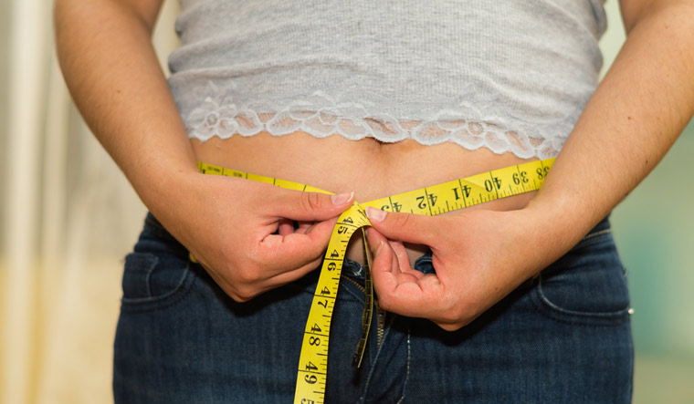 overweight-obese-obesity-woman-measure-health-belly-stomach-shut