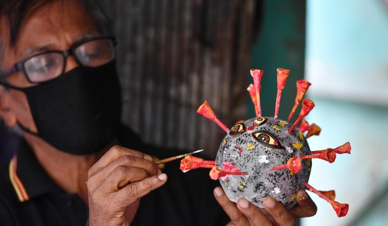 An artisan at Kolkata giving finishing touches on a coronavirus model | Salil Bera
