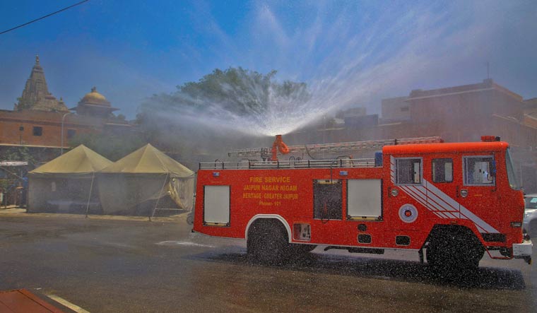 Fire brigade personnel sanitize the COVID-19 containment zone of Ramganj Chopad in Jaipur | PTI
