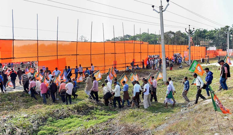 BJP activists and supporters enter the venue besides NH-31, prepared in anticipation of party president Amit Shah's rally to launch 'Save Democracy Rath Yatra', in Cooch Behar, West Bengal | PTI