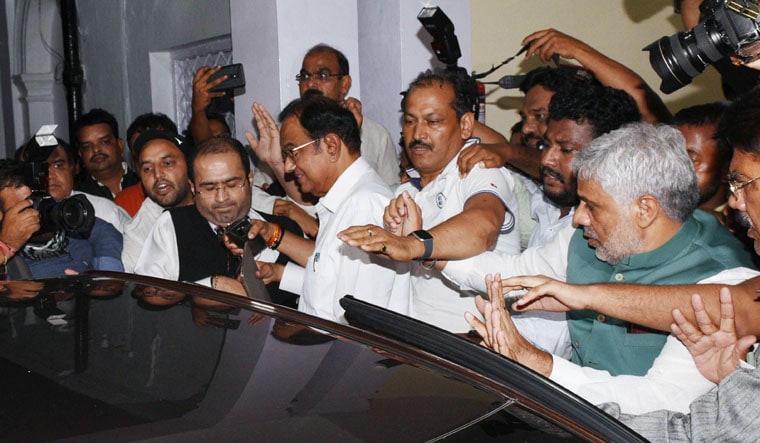 India's former finance minister and Congress party leader P. Chidambaram (C) leaves after a press conference at the party headquarters in New Delhi on August 21, 2019. - High drama unfolded in Delhi late on August 21 as officers from India's equivalent of the FBI scaled the walls of a former finance minister Chidambaram's home to arrest him on corruption charges, local media reported. (Photo by STR / AFP)
