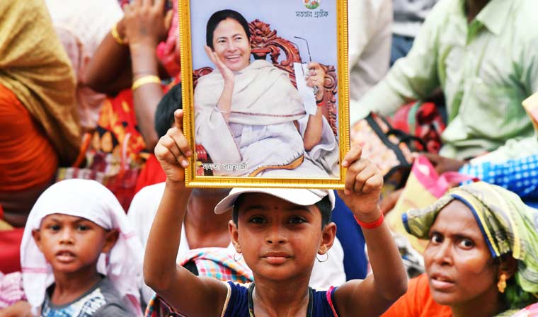 A child, holding a photograph of Chief Minister Mamata Banerjee, attending the Martyrs' Day rally in Kolkata | Salil Bera