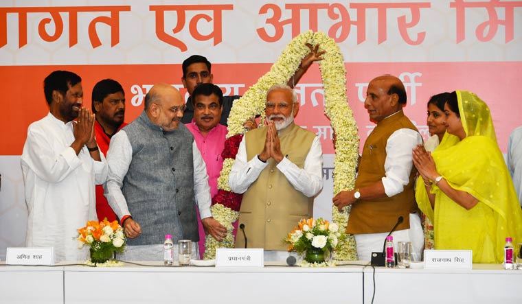 Prime minister Narendra Modi being welcomed with a huge garland by NDA ministers during a thanks giving ceremony at BJP headquarters in New Delhi | Arvind Jain