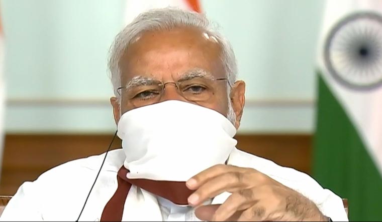 Prime Minister Narendra Modi wearing a protective mask chairs a meeting with chief ministers on COVID-19 lockdown via video conference | PTI