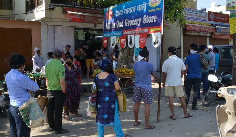 People stand in queue to by essential things outside a shop in Ghaziabad after the UP government decided to seal COVID-19 hotspots in 15 districts | Arvind K. Jain