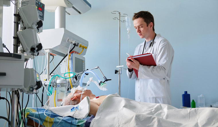 hospital-ICU-Intensive-care-doctor-examines-intubated-critical-stance-patient-shut